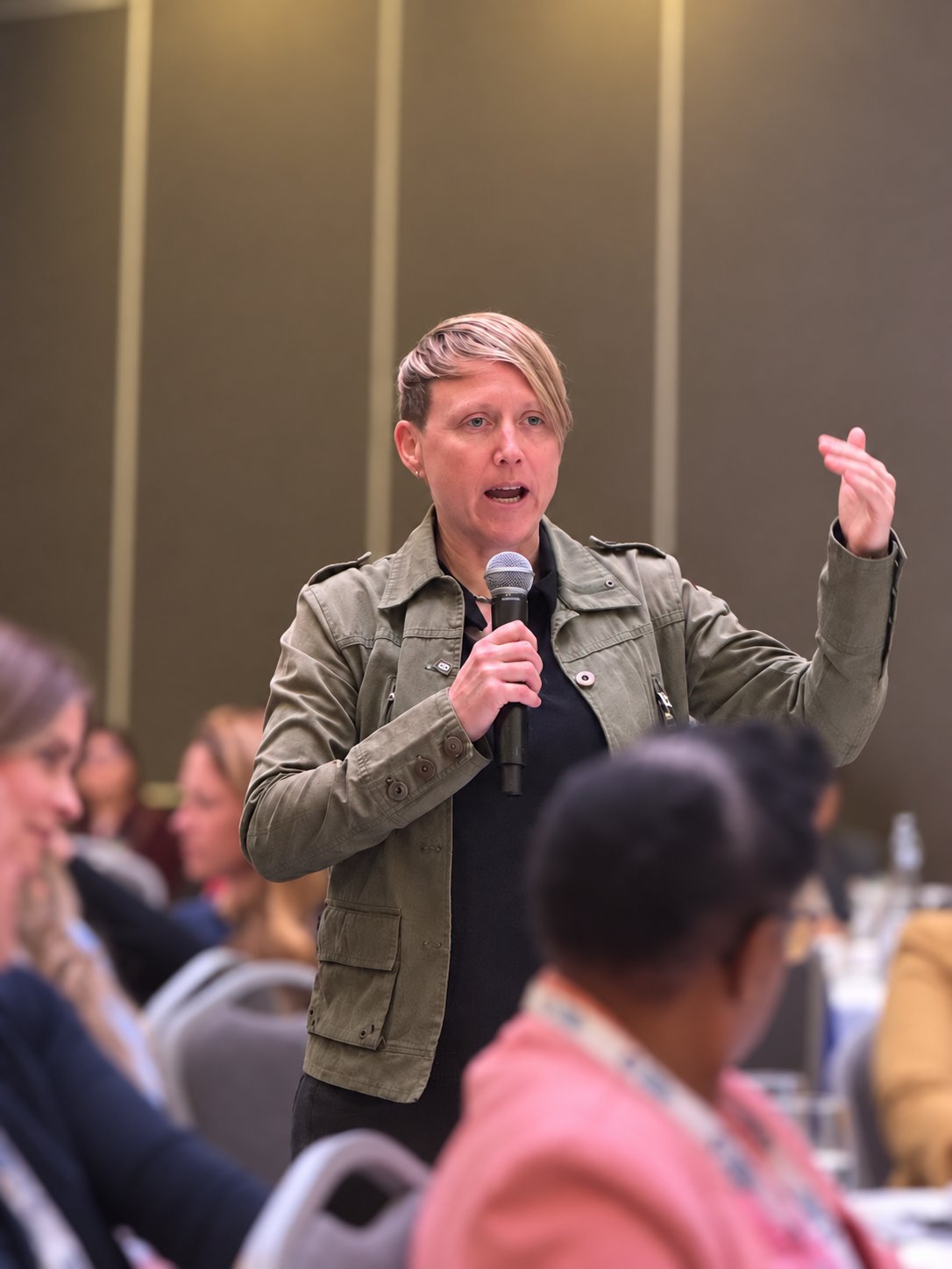 Ber Roberts speaking to an audience at an in-person event